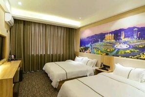 A hotel room with two beds, a desk, a painting of a cityscape, and a large window with curtains.