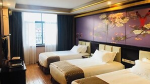 A hotel room with two beds, a desk, and a large window.