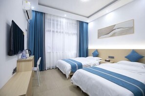 A hotel room with two beds, a desk, a chair, a TV, and a window with curtains. - Phoenix Bohan Inn (Fenghuang County)