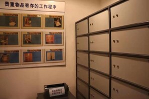 A storage area with metal cabinets and a poster with images. - Olympic ForYou Boutique Hotel (Changzhou)