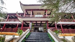 A traditional building with a staircase leading to a balcony. - Biancheng Gushi Theme Culture Hotel (Yongshun)