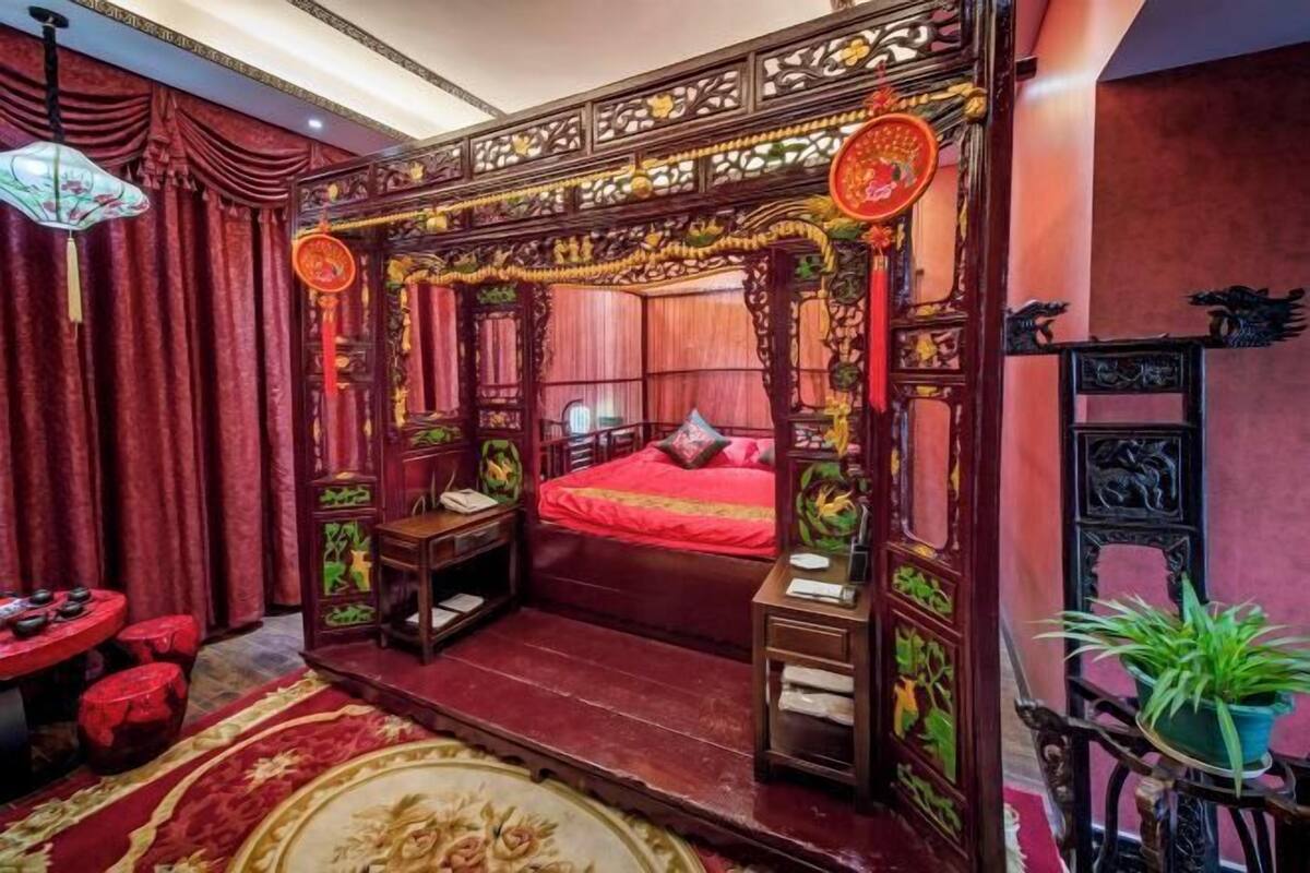 A traditional room with a bed, a small table, and a chair.