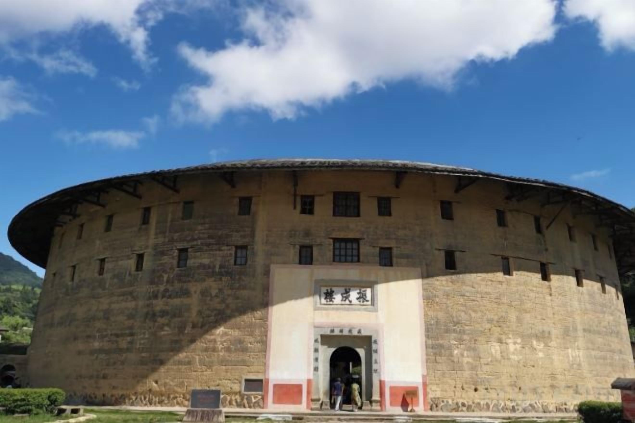 A large, circular building with a central entrance and a flat roof.
