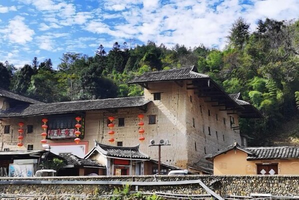 A traditional building with a tiled roof and a stone wall.