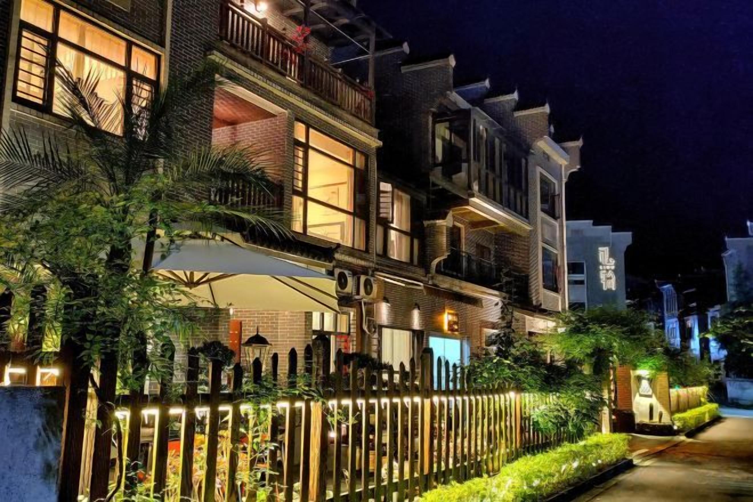 A multi-story residential building with balconies and a gated entrance.