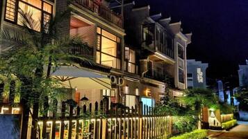 A multi-story residential building with balconies and a gated entrance.