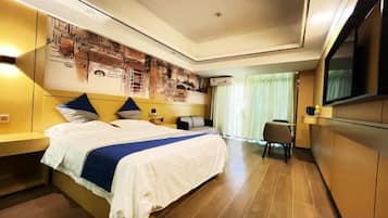 A hotel room with a large bed, a desk, a chair, a television, and a wall-mounted artwork.
