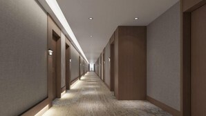 A long, narrow hallway with a patterned carpet and recessed lighting. - Yinhe Hotel (Burqin)