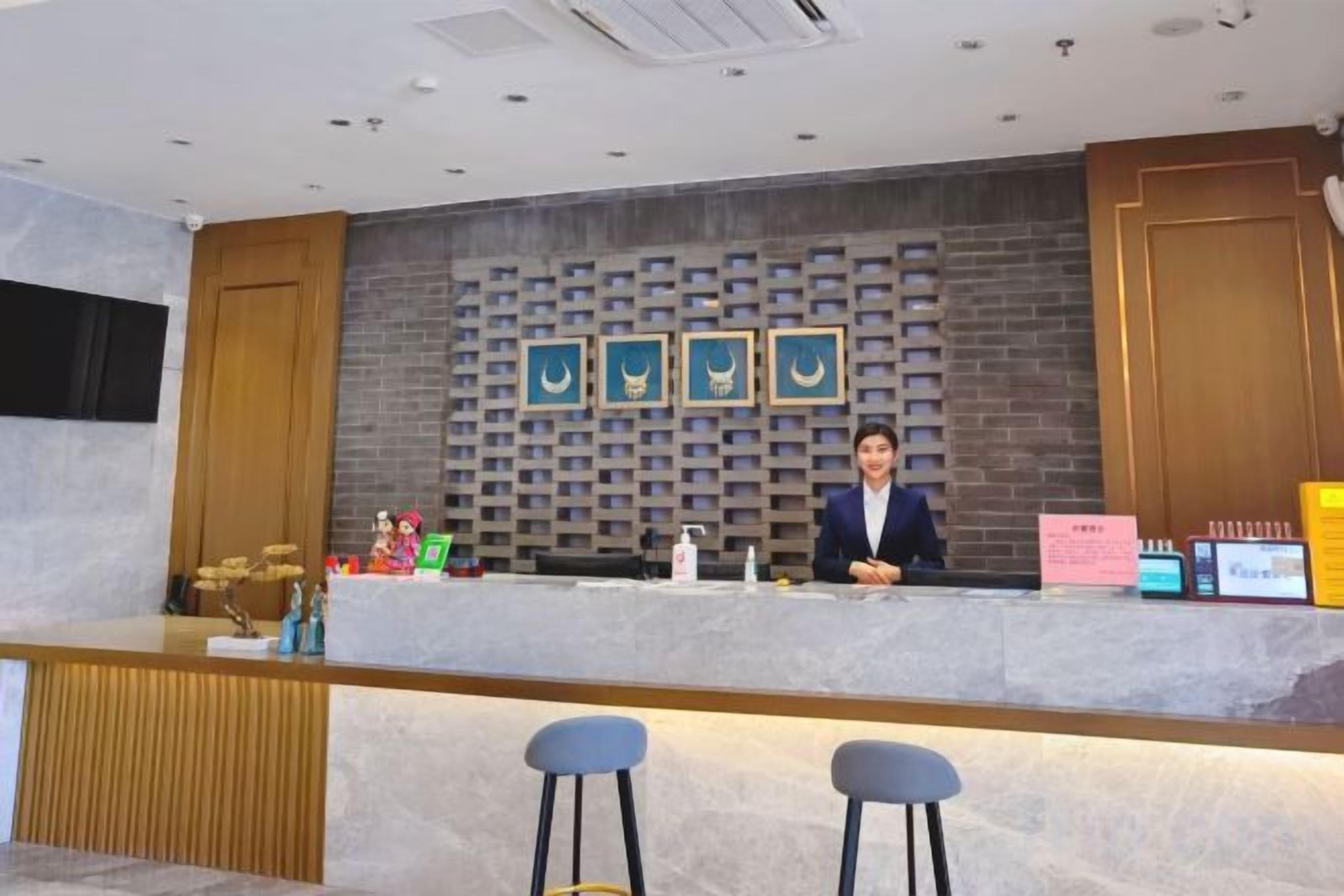 A reception desk with a modern design, a counter, and a seating area with stools.