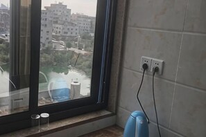 A room with a window, a radiator, and electrical outlets on the wall.