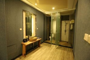 A modern bathroom with a wooden vanity, a large mirror, and a glass shower enclosure. - Baodi Spring Town (Fuxin County)
