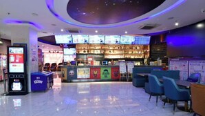 A modern indoor space with a bar area, seating, and digital menu displays. - Kailin International Hotel (Shenzhen Guangming Street subway station) (Shenzhen)