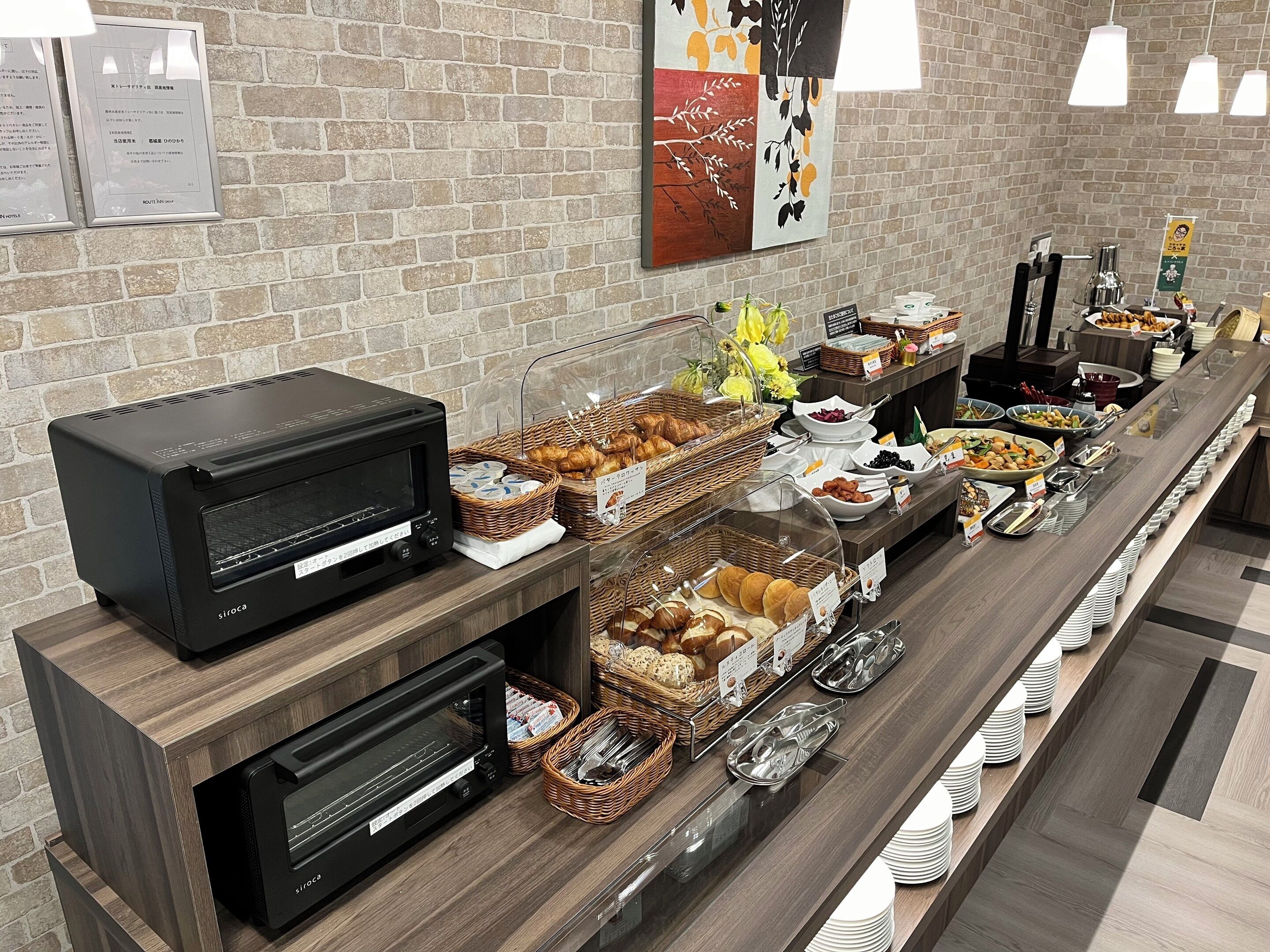A buffet setup with various food items and a microwave oven.