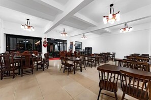 A spacious dining area with multiple tables and chairs, high ceilings, and pendant lighting fixtures. - Hanguanglou Hotel (Dali City)