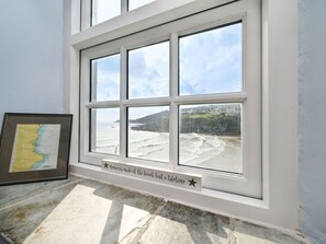 Enjoy breathtaking views of the beach and cliff from this room's large window.