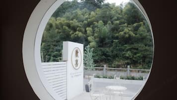 Hotel entrance with a circular window view of the surrounding forest.
