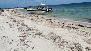 A beach with boats, clear skies, and calm waters. - Casita Bella Beautiful Cottage IN Wonderful Cape Coral FL. Come Enjoy! (Cape Coral)