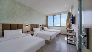 A hotel room with three beds, a TV, a desk, and a window with a view. - 99inn Selected (Beijing Huilongguan East Street Metro Station) (Beijing)