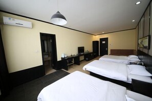 A hotel room with two beds, a desk, a chair, a TV, and an air conditioning unit. - Tai 9 Hotel (duelbert) (Dorbod County)