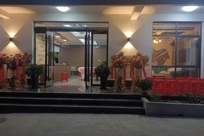 A hotel entrance with glass doors, a staircase, and indoor plants. - Tianzhushan Motu Station Homestay (Qianshan)