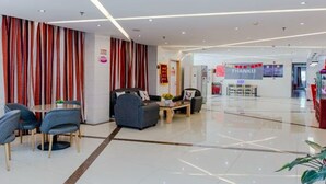 A modern hotel lobby with a reception desk, seating area, and a 'THANKU' sign. - Thank You Inn Beijing Huairou Yanqi (Huairou)