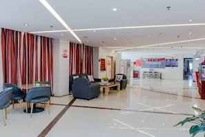 A modern hotel lobby with a reception desk, seating area, and a 'THANKU' sign. - Thank You Inn Beijing Huairou Yanqi (Huairou)