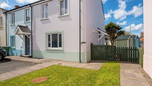 A two-story residential building with a flat roof, a front door, and a small porch. - Cwtch Cottage, Holiday Cottage Broad Haven, Sleeps 5, 3 bedrooms,  bathrooms (Haverfordwest)