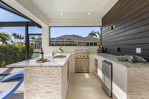 Fridge, microwave, oven, stovetop - Gorgeous! Heated, Saltwater Pool and Spa, Custom Outdoor Kitchen - Villa Still Waters - Roelens (Cape Coral)