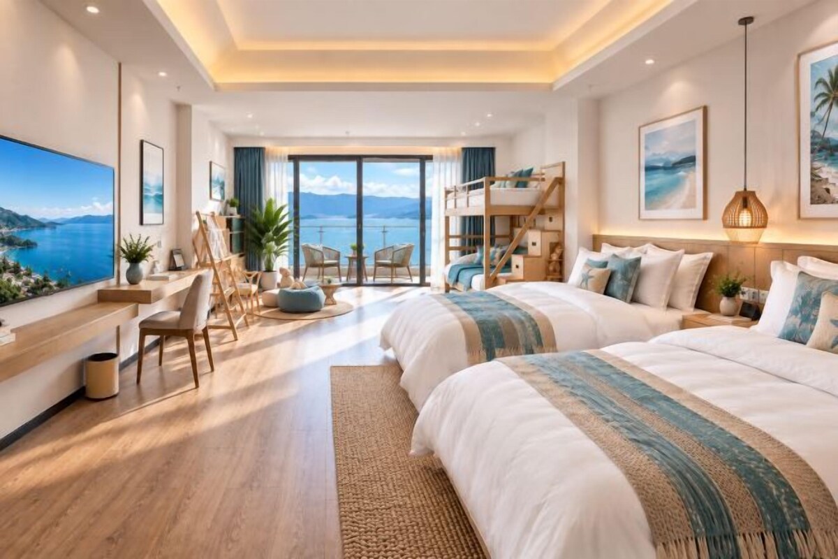 A modern bedroom with two beds, a desk, and a view of the sea.