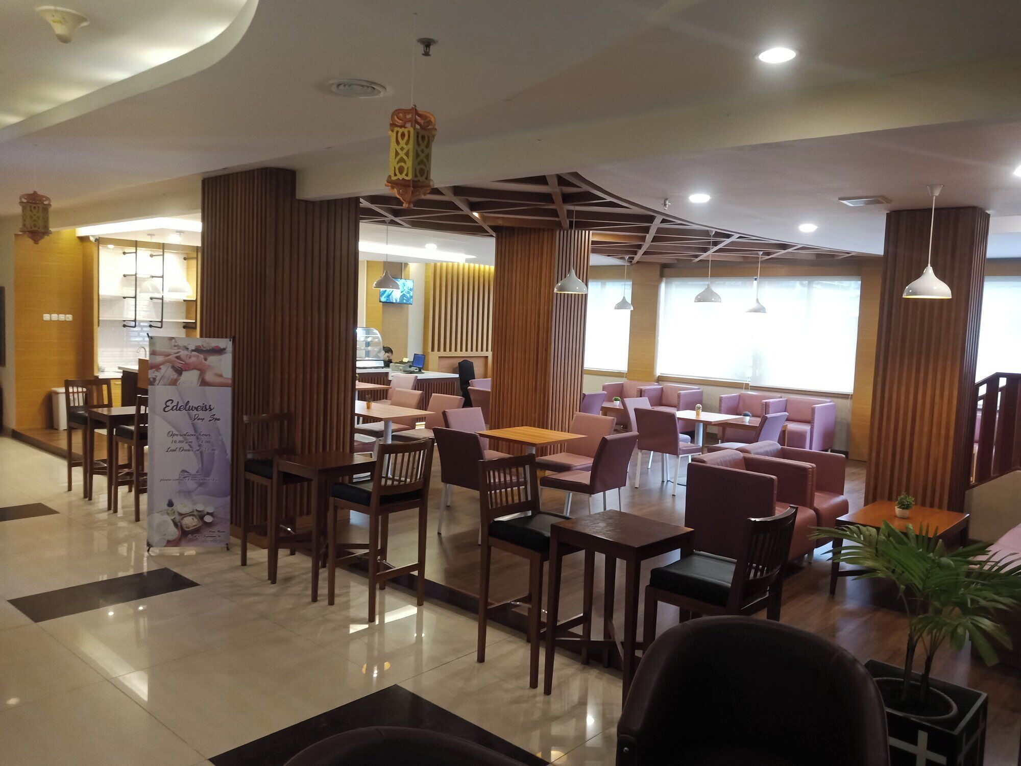 A modern restaurant with wooden furniture and a clean, polished floor.