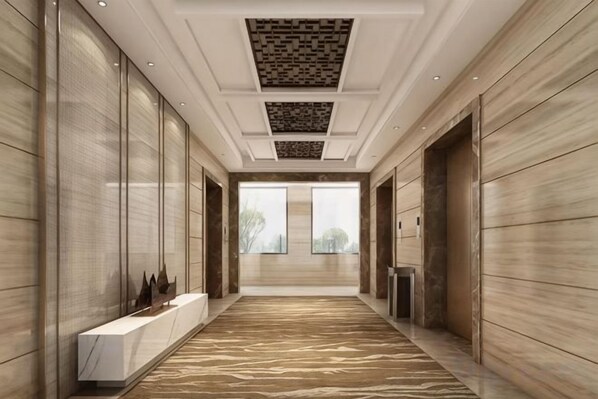 A corridor with a marble floor, wooden panel walls, and a ceiling with recessed lighting. - Shimao Tuke China Hotel wuhu (Wuhu)