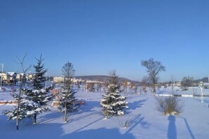 A snow-covered landscape with trees and buildings in the background. - Yichun Wengxinyuan Family Guesthouse (Tangwang County)
