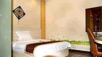 A bedroom with a bed, a chair, a wall-mounted TV, and a decorative wall piece.