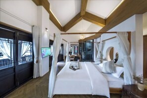A modern bedroom with a large bed, wooden beams, a TV, and a view of the outdoors. - Yunyi Hot Spring Zangpin Inn (Tengchong)