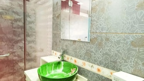A bathroom with a green vessel sink, a mirror, and patterned tiles. - Bazhong city home business hotel (Bazhong)