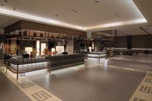 A spacious hotel lobby with a central island, seating areas, and a modern design. - JP Hyllis Hotel (Lijiang)