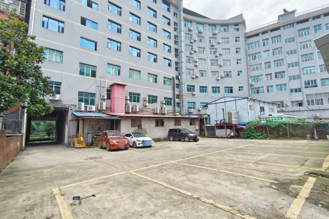 A multi-story parking garage with several cars parked.