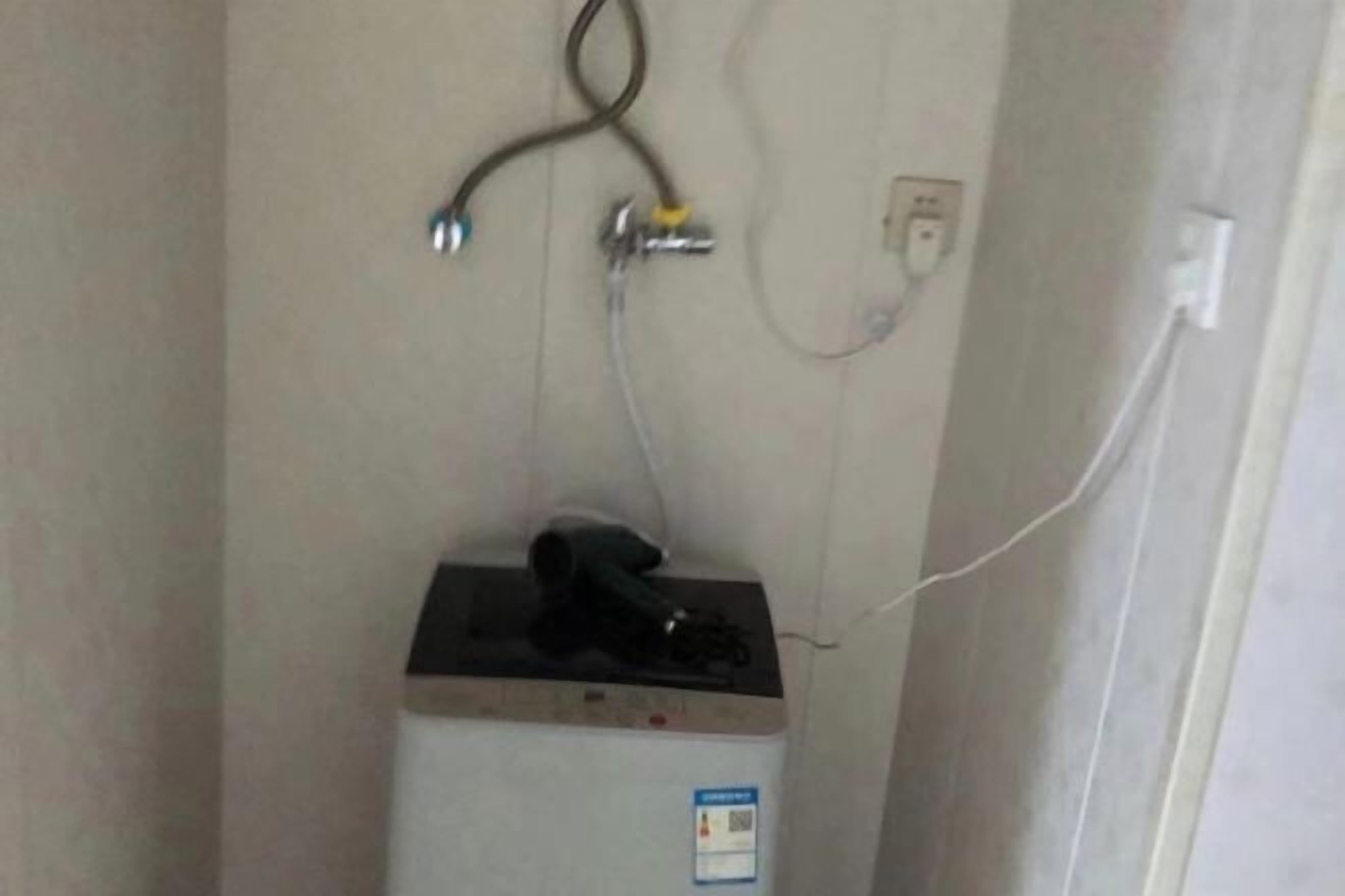 A power outlet with a plug connected to a device on a white surface.