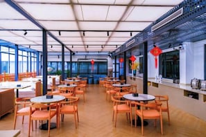 An indoor dining area with tables and chairs arranged for guests. - Metropolis Hotel (Sanya Bay Coconut Dream Corridor) (Sanya)