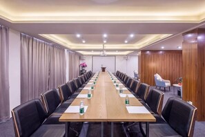 A conference room with a long table, chairs, and a podium. - Metropolis Hotel (Sanya Bay Coconut Dream Corridor) (Sanya)