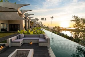 A modern resort with a long pool, outdoor seating, and a sunset view. - The Hotel Elizabeth Resort and Villas (San Vicente)