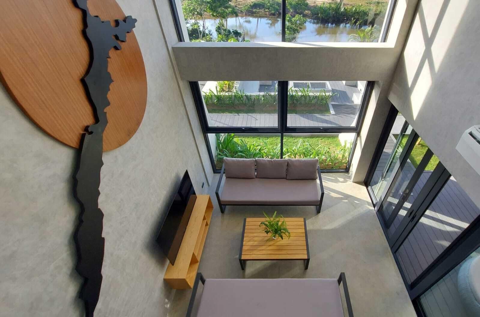A modern interior with a sofa, coffee table, and a unique wall art piece.