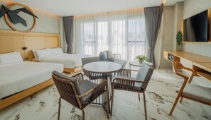 A hotel room with two beds, a dining table with chairs, a TV, and a large window with curtains. - The Hotel Elizabeth Resort and Villas (San Vicente)