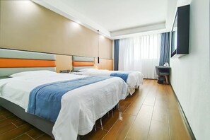 A hotel room with two beds, a desk, a chair, and a TV mounted on the wall. - Longding Business Hotel (Nanchang)