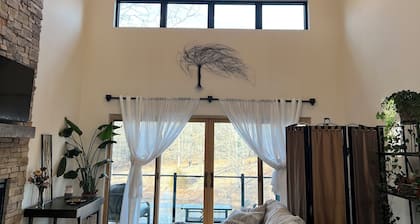 Beautiful Modern mountain getaway overlooking water with fountain.