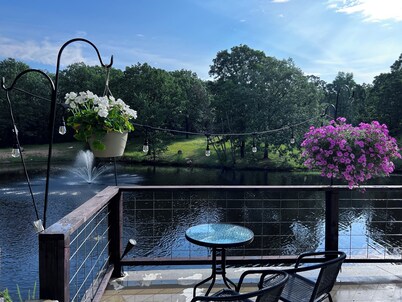 Beautiful Modern mountain getaway overlooking water with fountain.