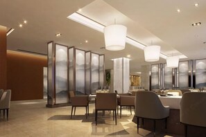 A modern dining area with high ceilings, recessed lighting, and contemporary furniture. - Dalian yuanfeng hotel (Dalian)