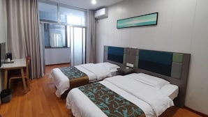 A hotel room with two beds, a desk, a chair, and a window with curtains. - Qiqi Hotel (Taiyuan Zhenwu Road Wanmaqi Square) (Taiyuan)