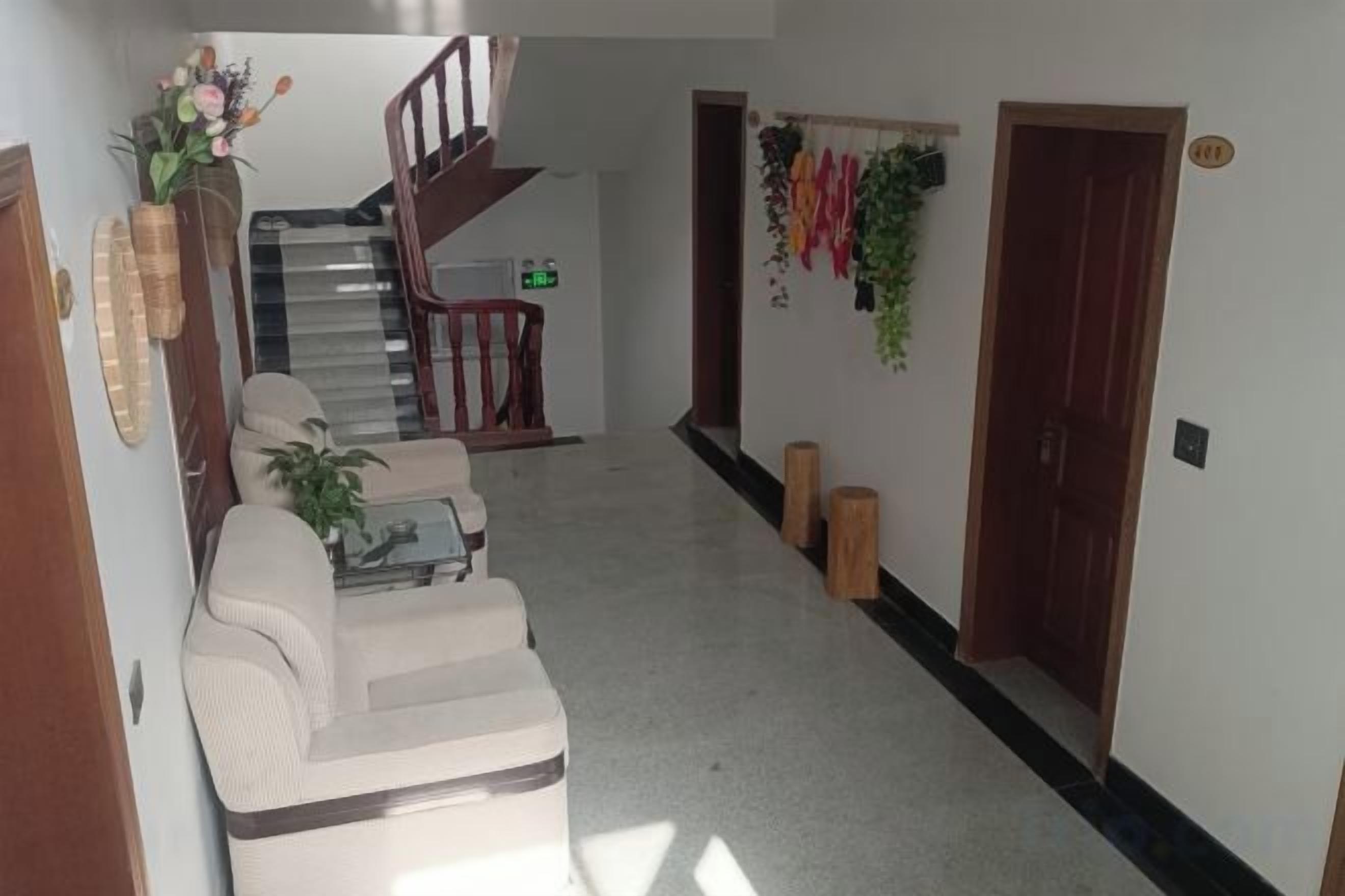 A hallway with a staircase, a sofa, and a coffee table.