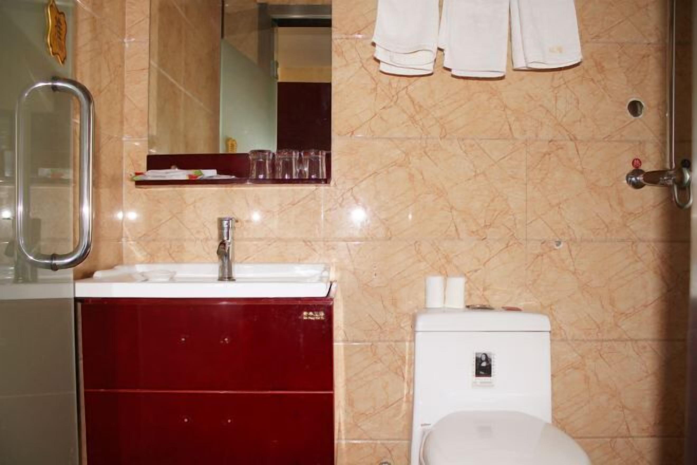 Ein Badezimmer mit Waschbecken, Spiegel und Toilette.